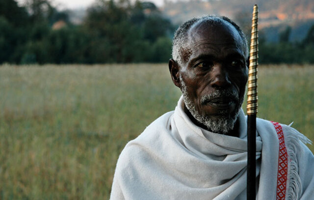 indigenous man standing in a field